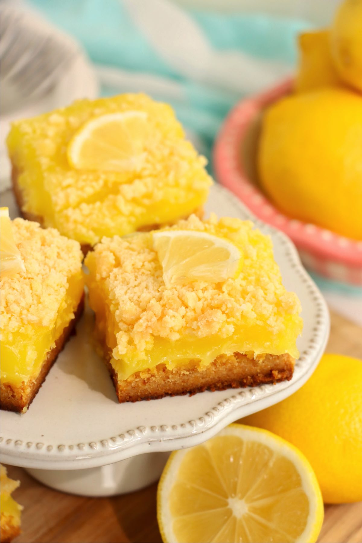 lemon bars on white dessert pedestal