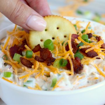 dipping Ritz cracker in million dollar dip