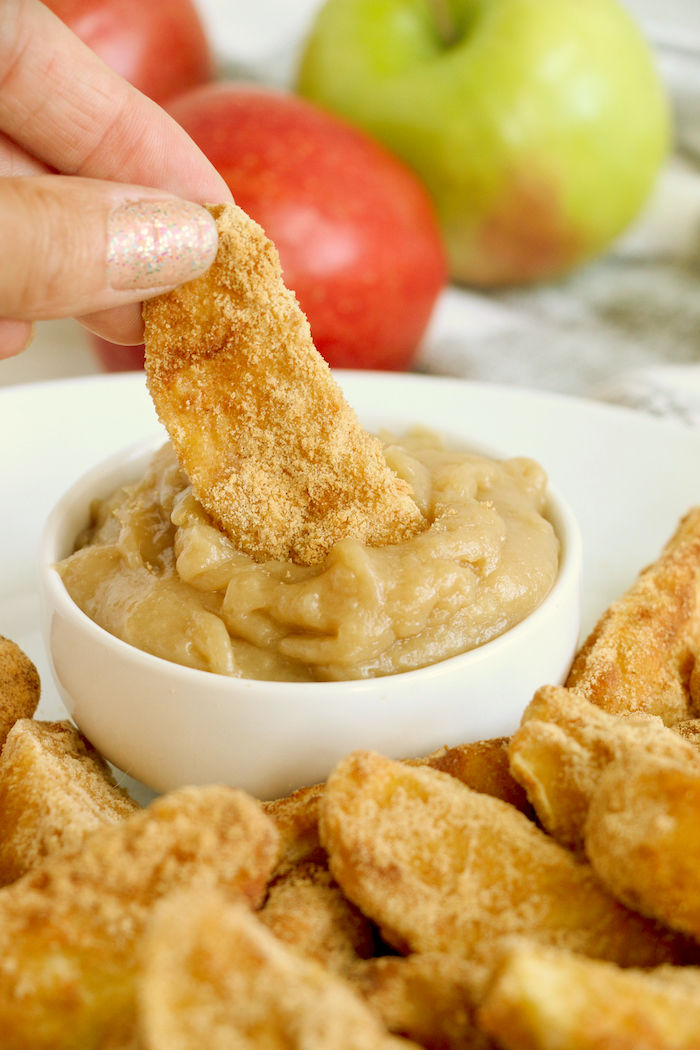 Dipping air fryer apple fry in caramel dip