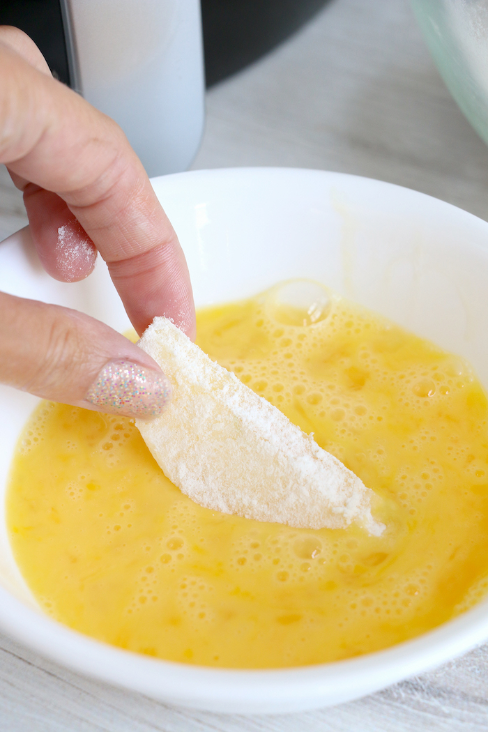 dipping apple wedge in butter