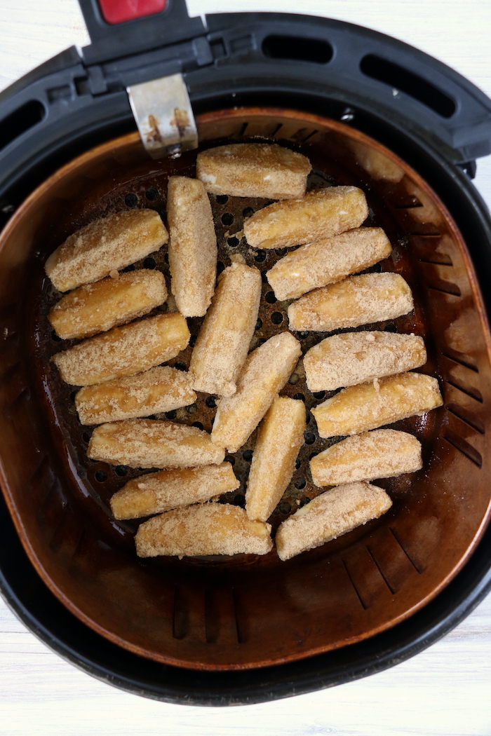 Apple slices in an air fryer basket