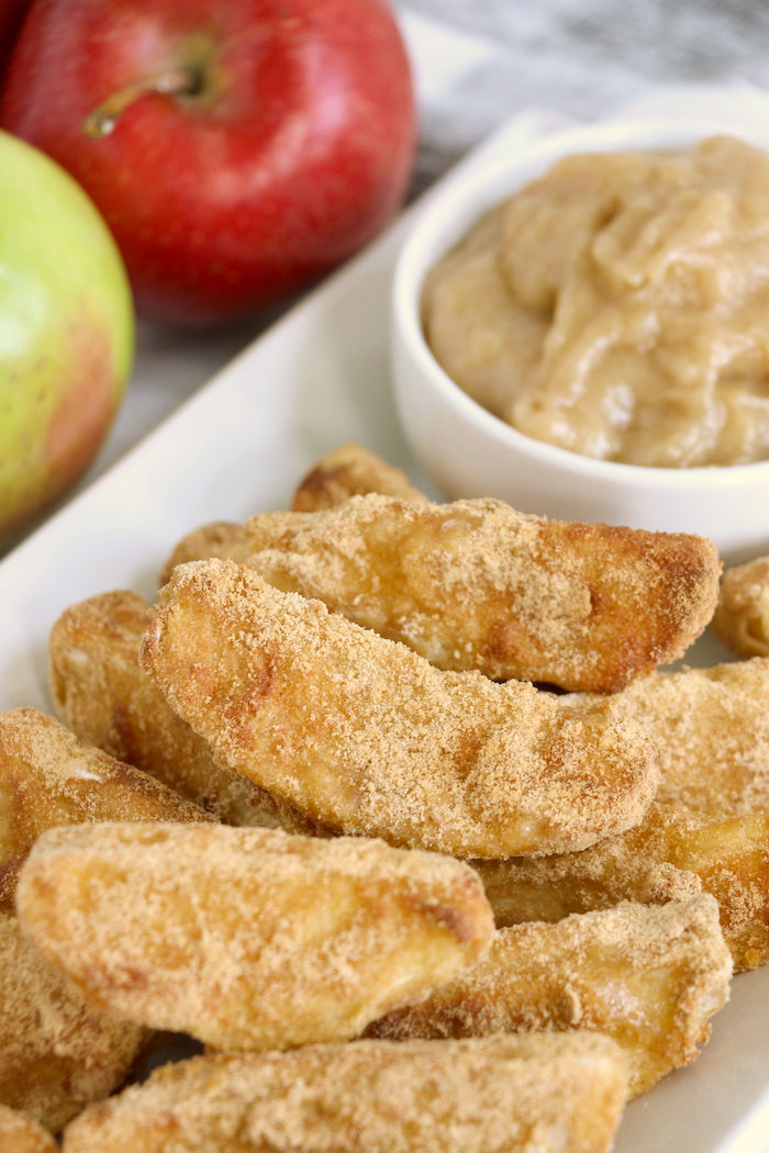 Air fryer apple fries with caramel dip on white platter