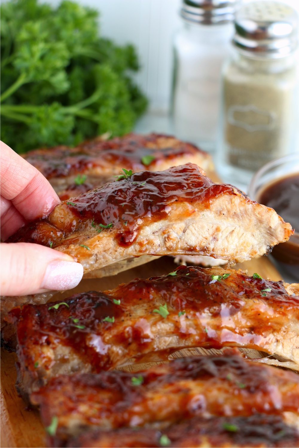 holding piece of BBQ ribs
