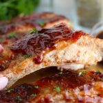 hand holding up a saucy riblet