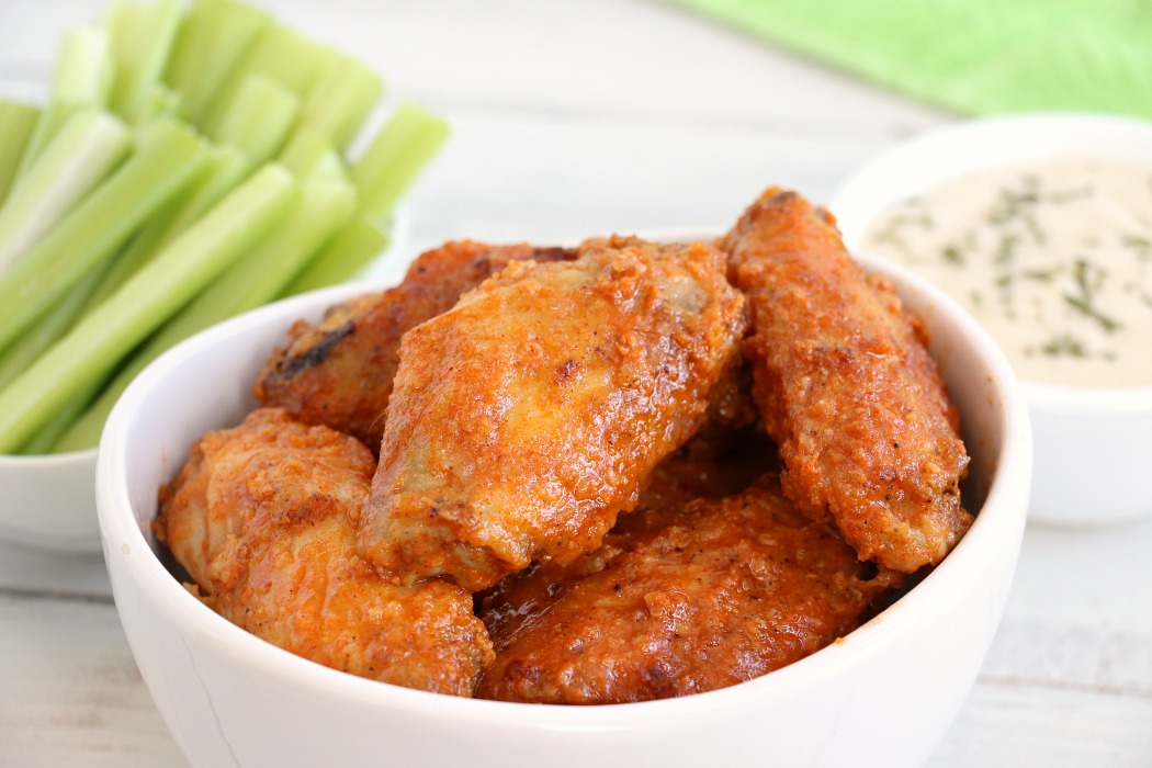 Air Fryer Chicken Wings - Delicious hot wings made in the air fryer in under 20 minutes. Use the sauce recipe provided or choose your favorite sauce!