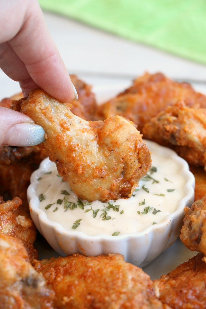 Air Fryer Chicken Wings - Delicious hot wings made in the air fryer in under 20 minutes. Use the sauce recipe provided or choose your favorite sauce!