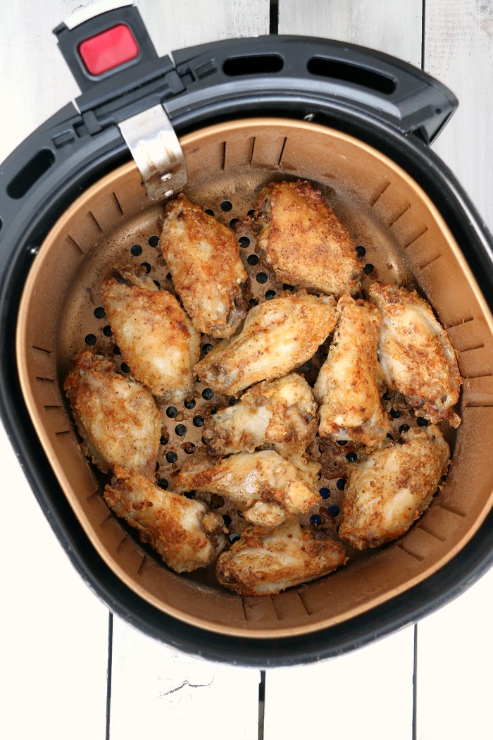 Air Fryer Chicken Wings - Delicious hot wings made in the air fryer in under 20 minutes. Use the sauce recipe provided or choose your favorite sauce!
