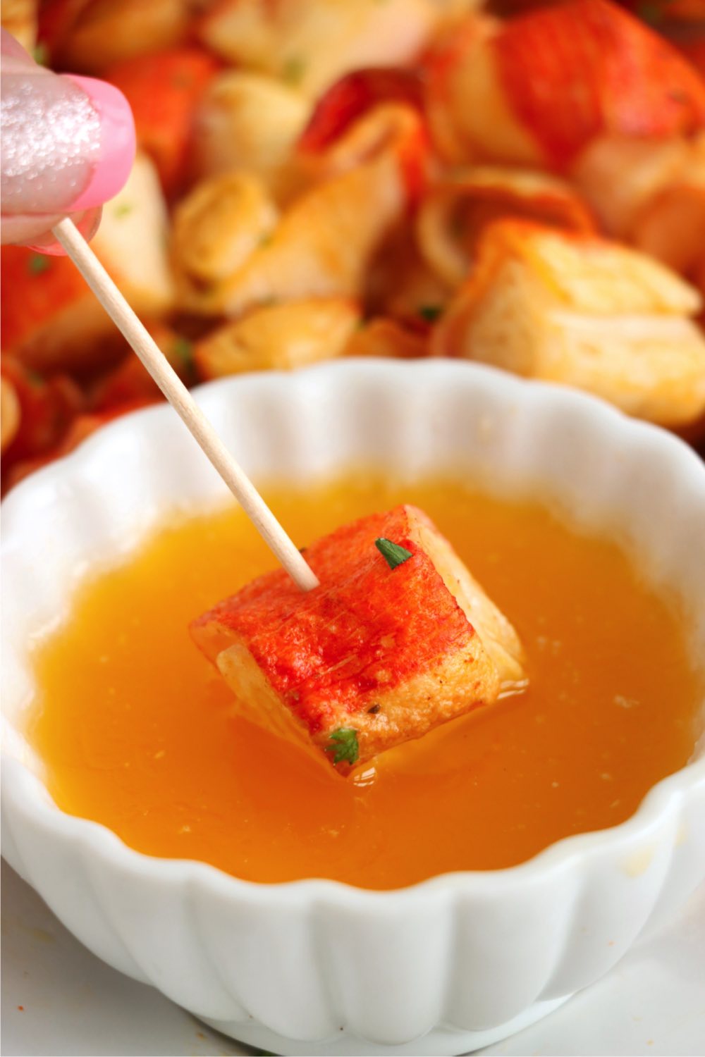 dipping a piece of crab into melted butter