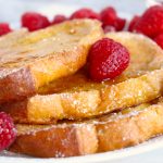 French toast with maple syrup and raspberries