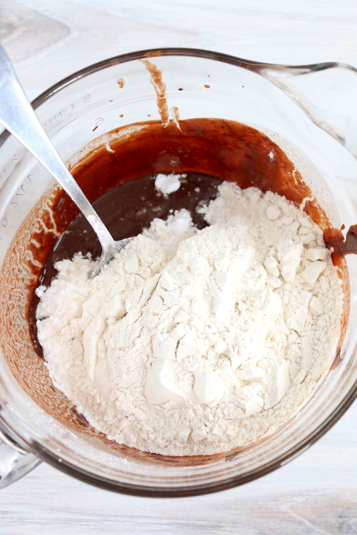 powdered sugar and flour in a bowl with melted chocolate
