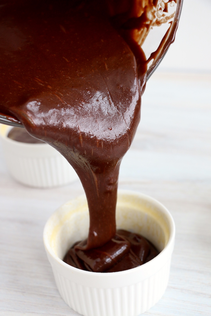 pouring chocolate batter into a ramekin
