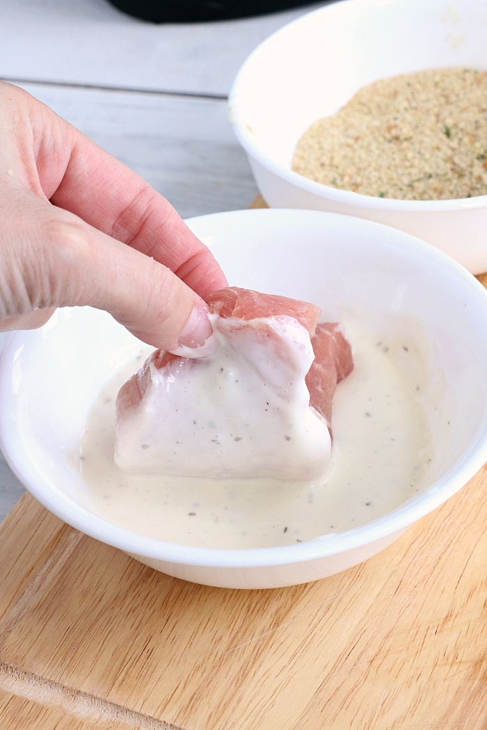 Air Fryer Pork Chops - Pork chops dredged in ranch dressing, coated in a parmesan cheese breadcrumb mixture and air fried to perfection. Tender on the inside and crispy on the outside!