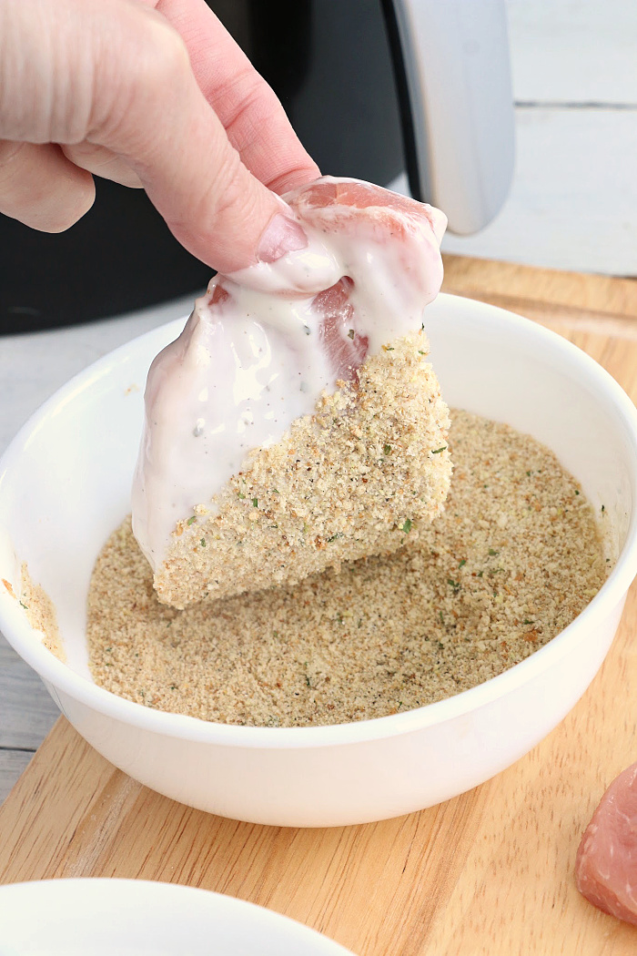 Air Fryer Pork Chops - Pork chops dredged in ranch dressing, coated in a parmesan cheese breadcrumb mixture and air fried to perfection. Tender on the inside and crispy on the outside!