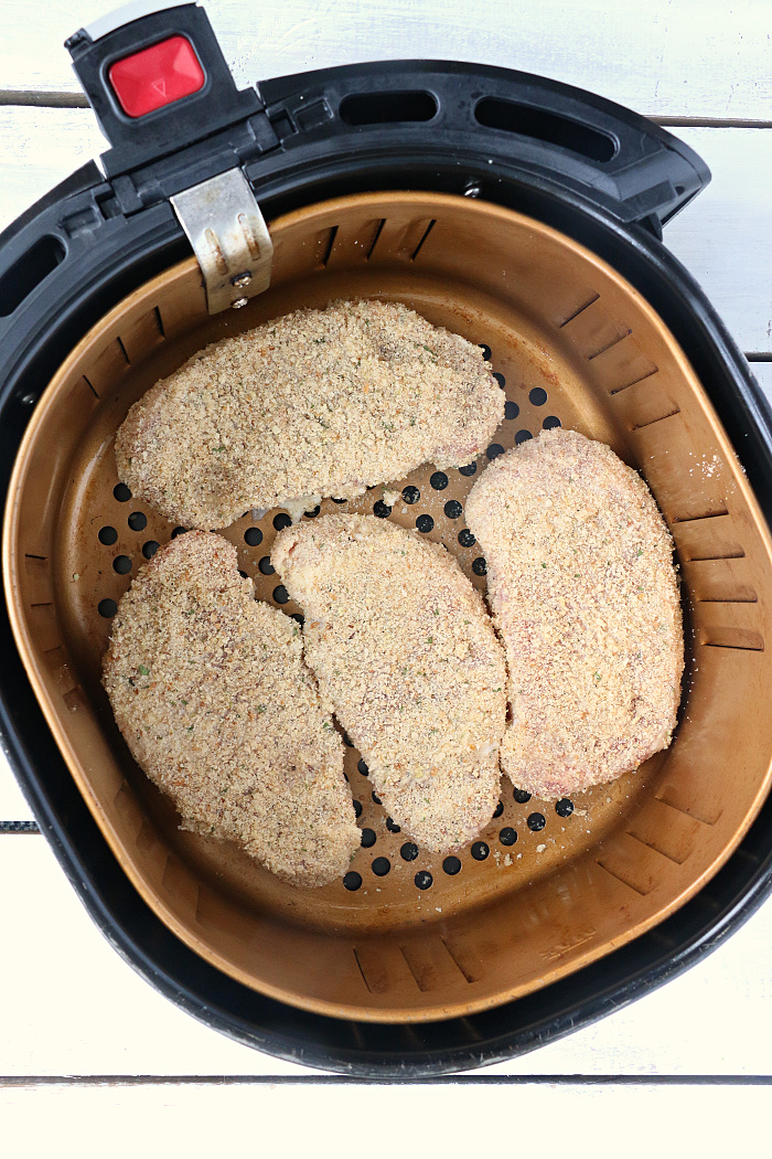 Air Fryer Pork Chops - Pork chops dredged in ranch dressing, coated in a parmesan cheese breadcrumb mixture and air fried to perfection. Tender on the inside and crispy on the outside!