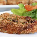 Air Fryer Pork Chops - Pork chops dredged in ranch dressing, coated in a parmesan cheese breadcrumb mixture and air fried to perfection. Tender on the inside and crispy on the outside!