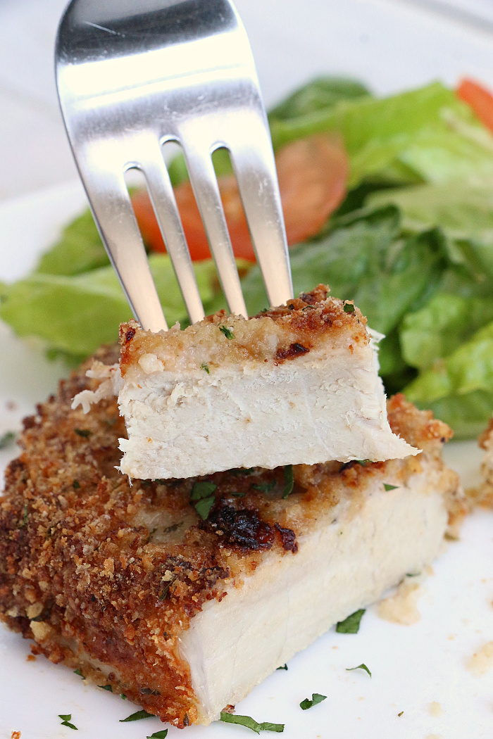 Air Fryer Pork Chops - Pork chops dredged in ranch dressing, coated in a parmesan cheese breadcrumb mixture and air fried to perfection. Tender on the inside and crispy on the outside!