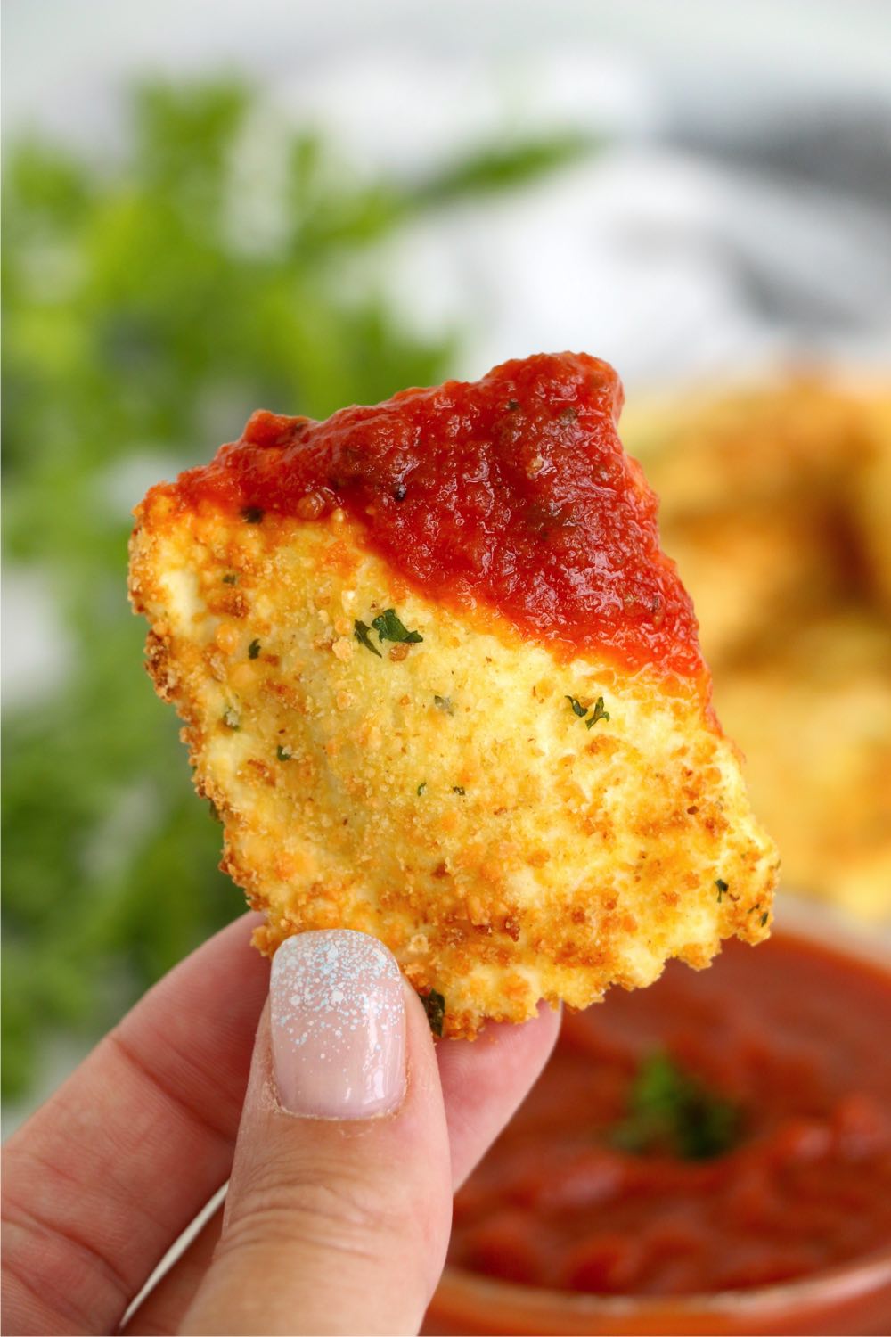 Ravioli dipped in marinara sauce