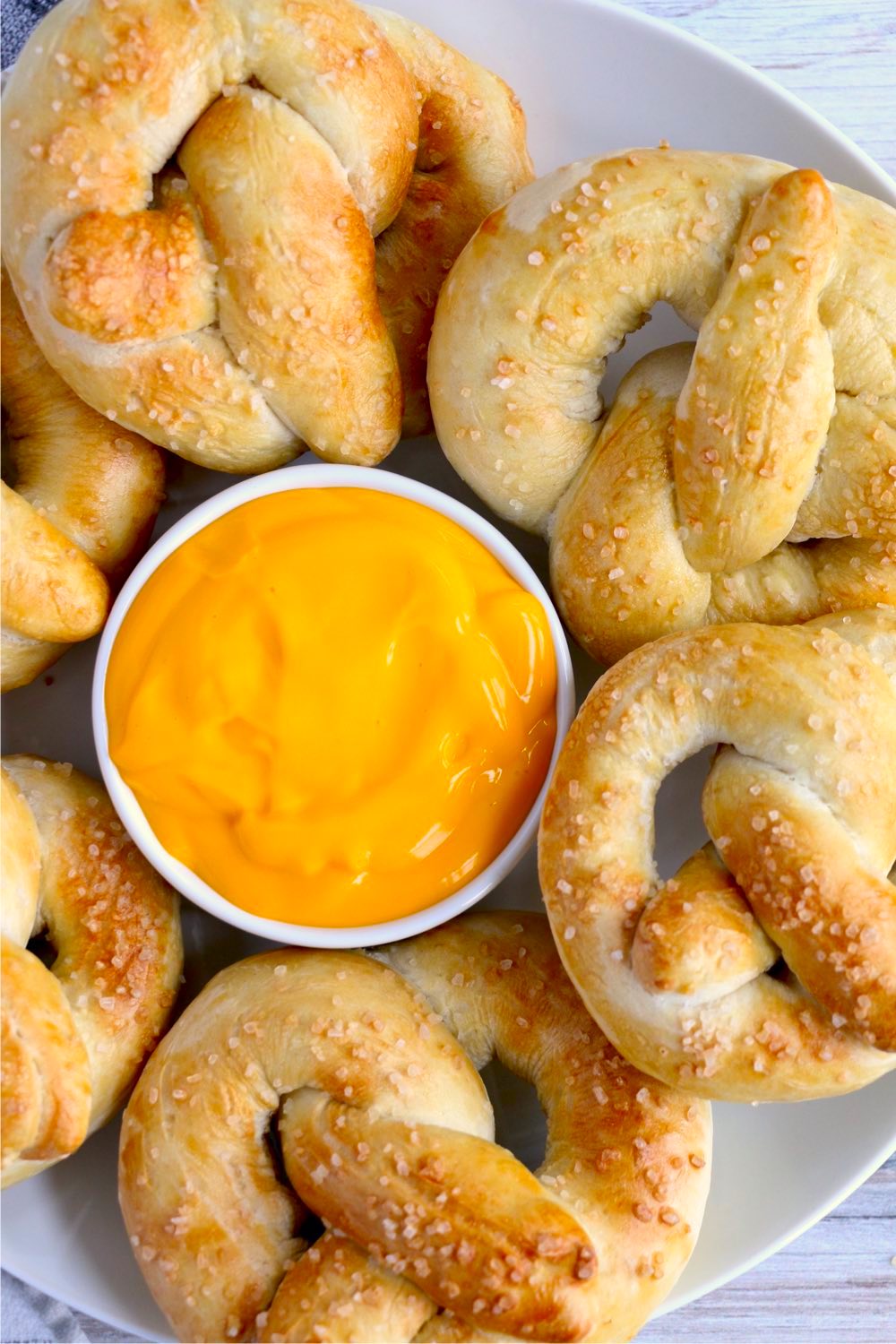 soft pretzels surrounding bowl of cheese dip