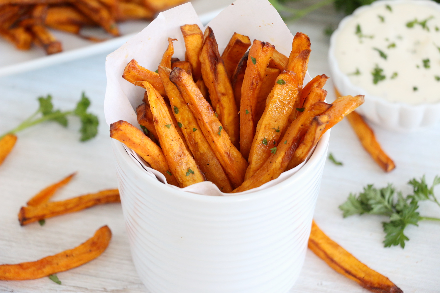 white cup with sweet potato fries