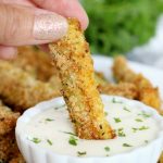 dipping a zucchini fry in ranch