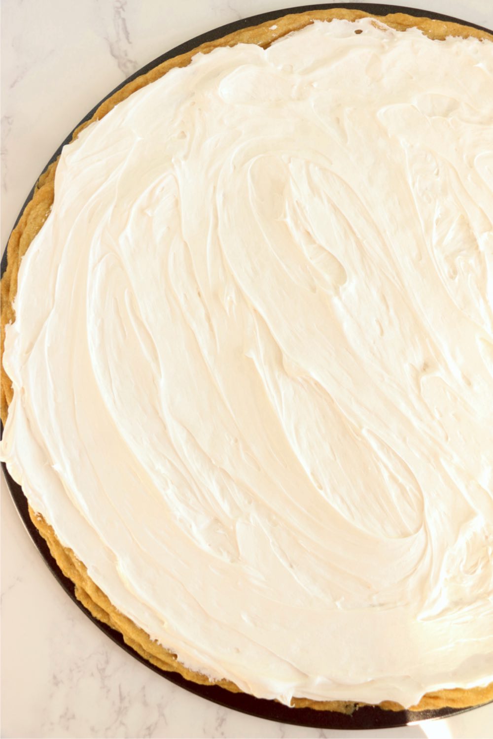 Frosted sugar cookie crust in the shape of a pizza