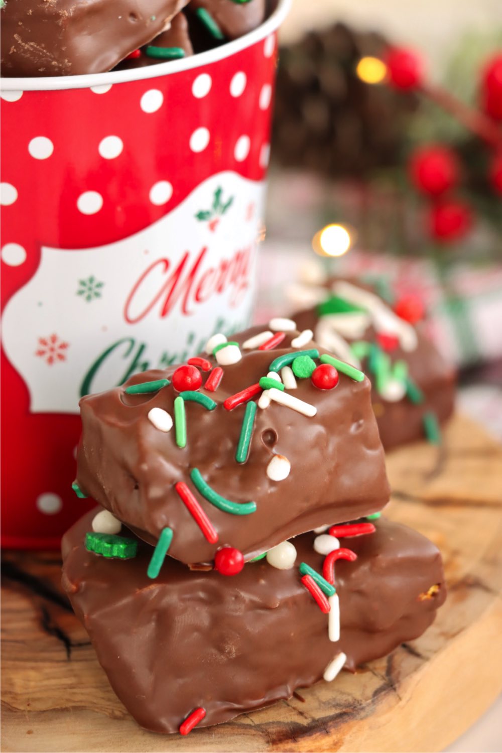 angel food candy pieces in front of a Christmas tin