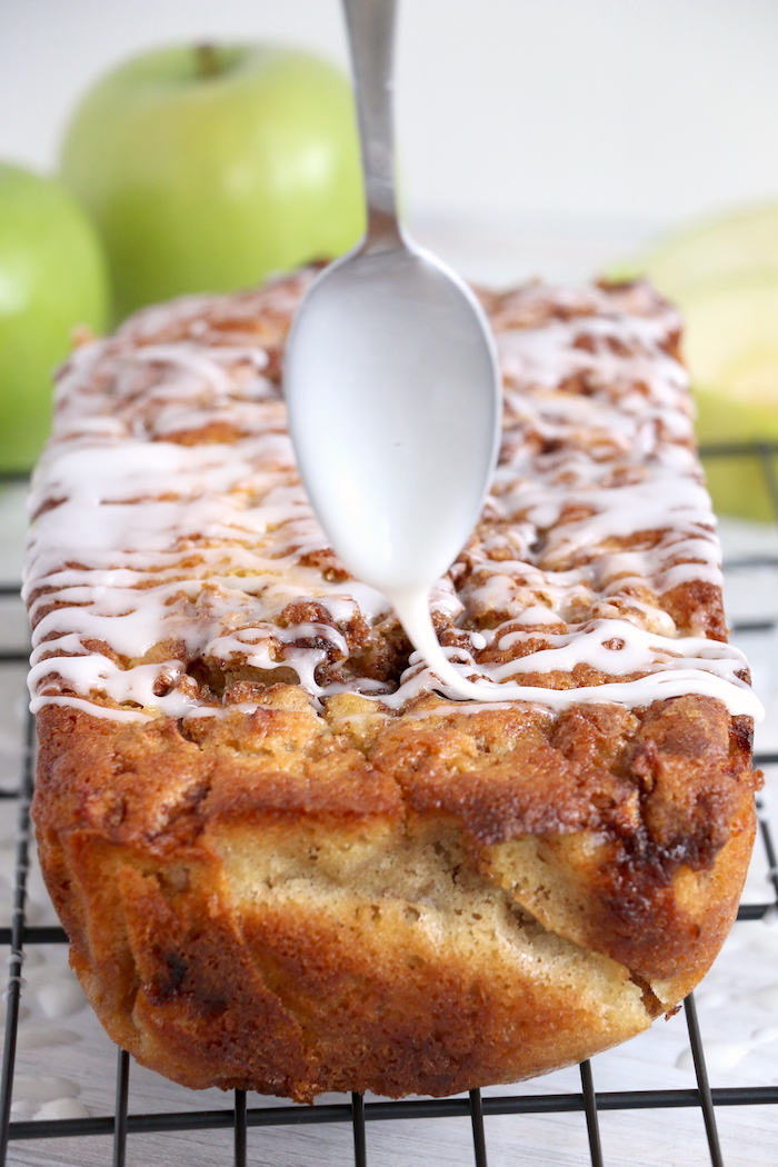drizzling an apple bread loaf with icing