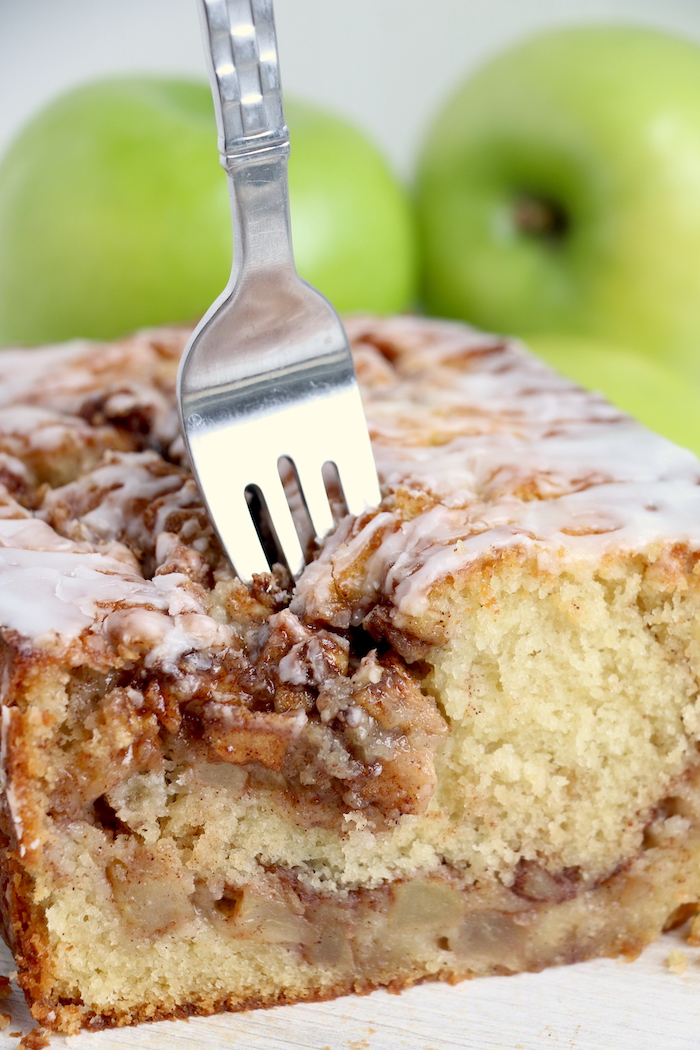 a fork going into a loaf of fresh apple bread