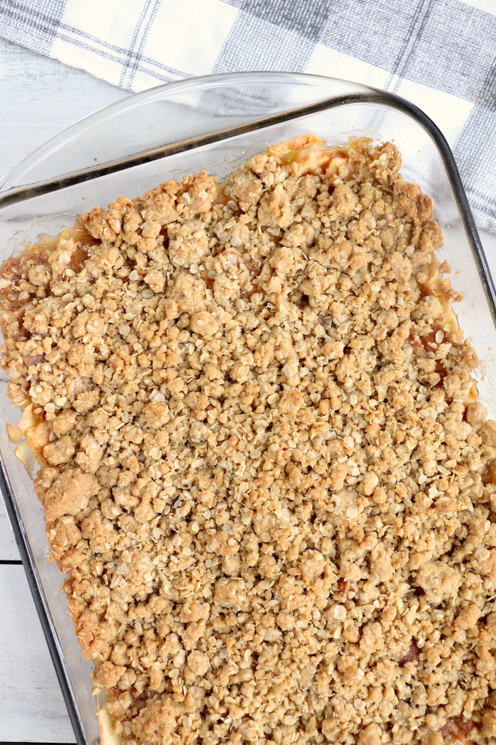 Easy Apple Crisp - A delicious, old-fashioned crisp made with sliced apples and a crunchy brown sugar oat topping. A scoop of vanilla ice cream and salted caramel sauce puts it over the top!