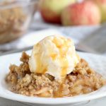 Easy Apple Crisp - A delicious, old-fashioned crisp made with sliced apples and a crunchy brown sugar oat topping. A scoop of vanilla ice cream and salted caramel sauce puts it over the top!