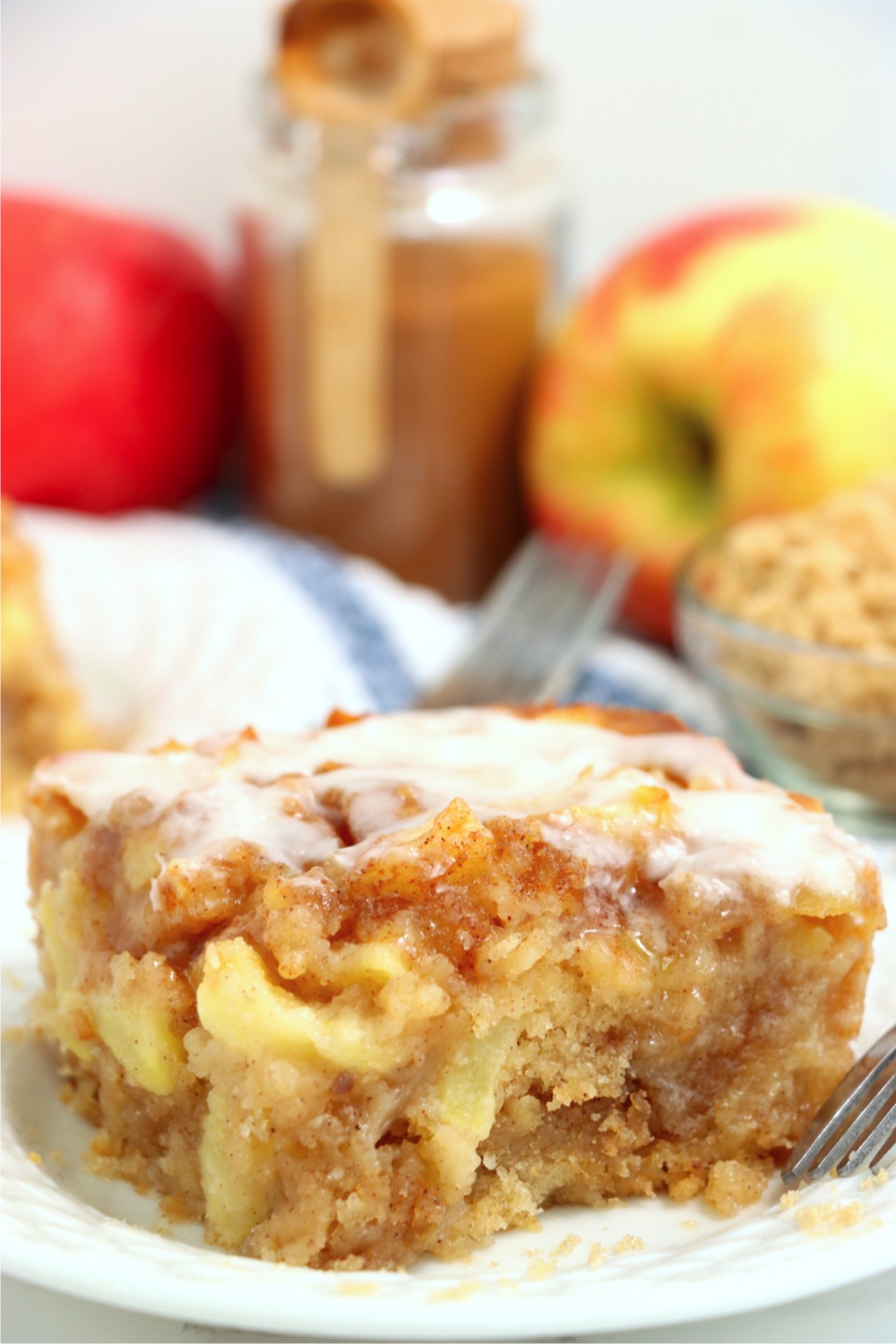 piece of apple fritter cake with vanilla glaze