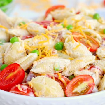 Pasta salad with peas, tomatoes, cheese and ranch dressing.