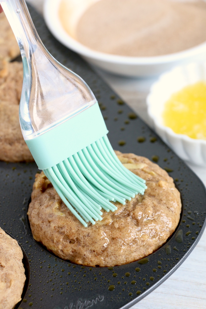 Brushing baked donuts with butter