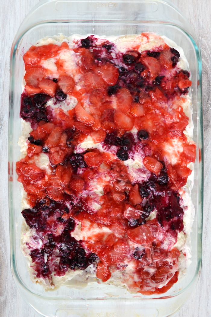 strawberries and blueberries on top of angel food cake pieces