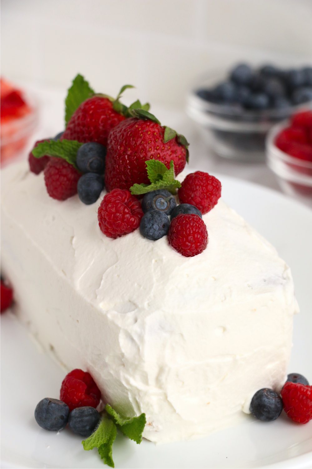 Frosted pound cake covered in fresh berries