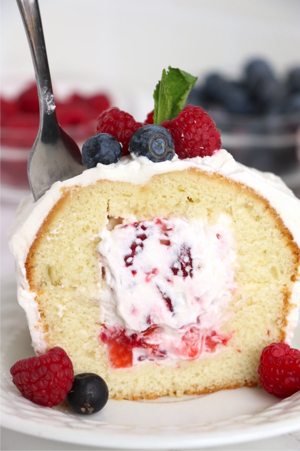 fork going into whipped cream stuffed cake