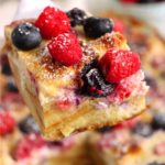 spatula holding piece of berry croissant casserole