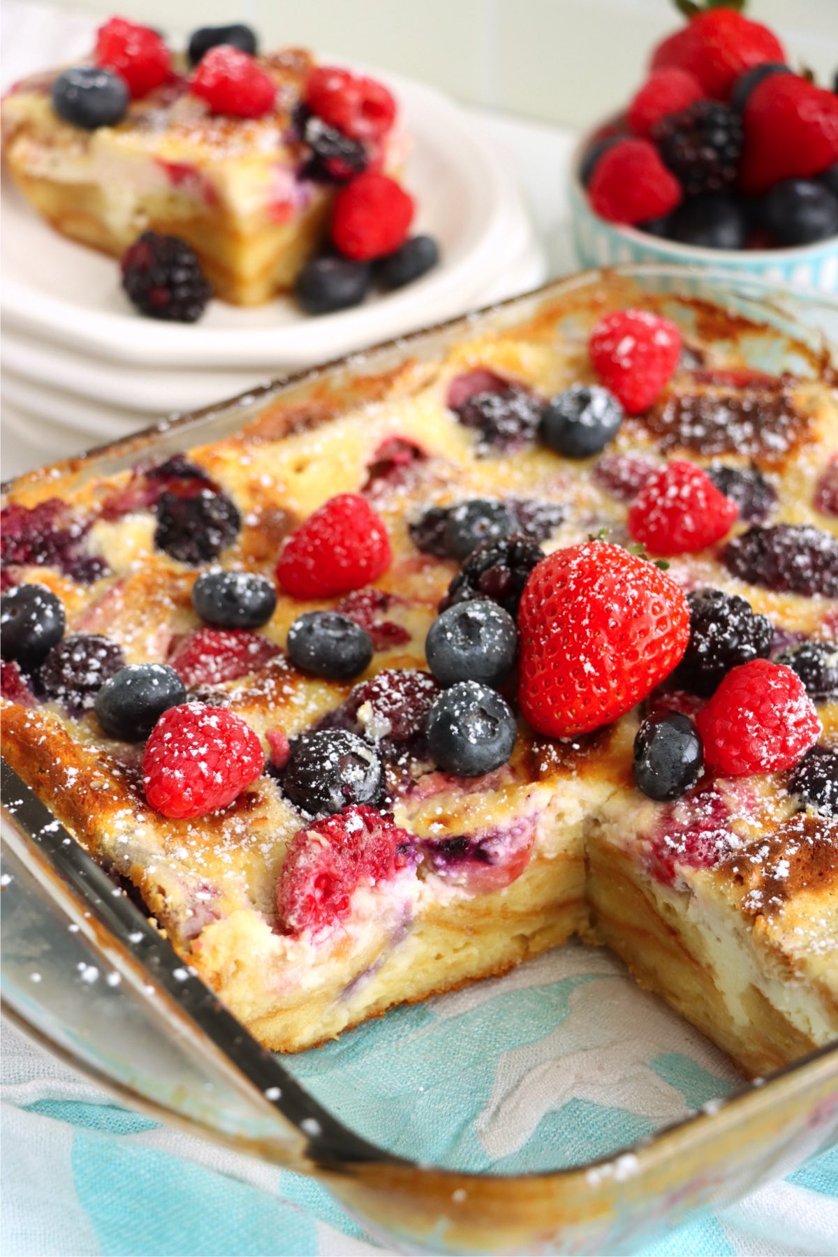 piece taken out of a berry and custard dessert