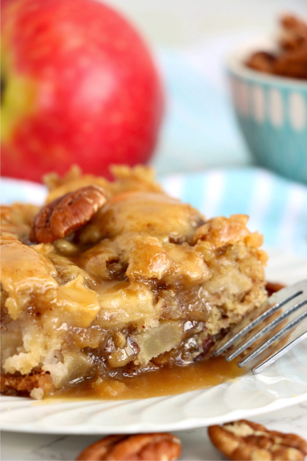 fork next to piece of apple cake with glaze