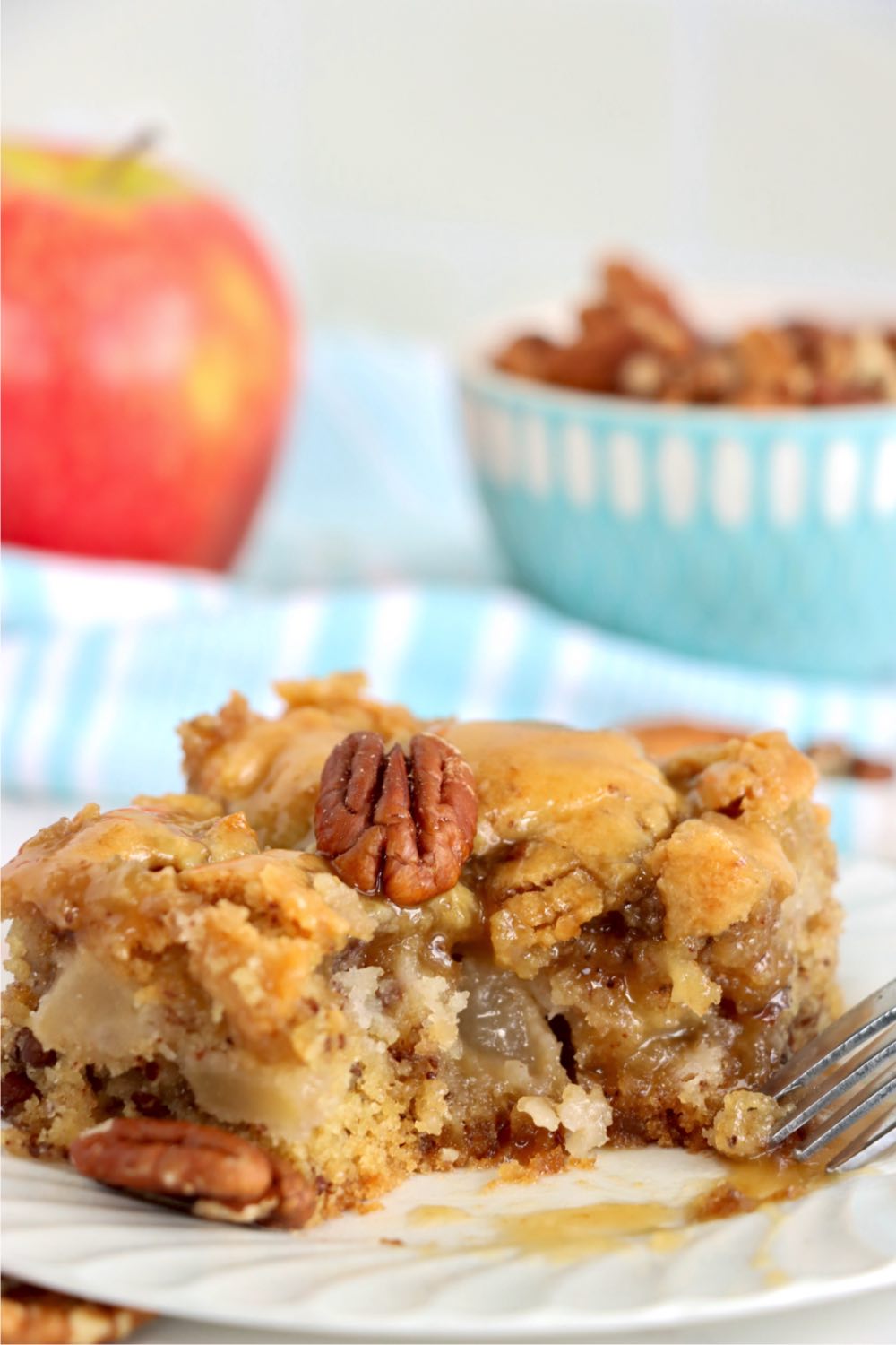 bite out of an apple cake on a plate