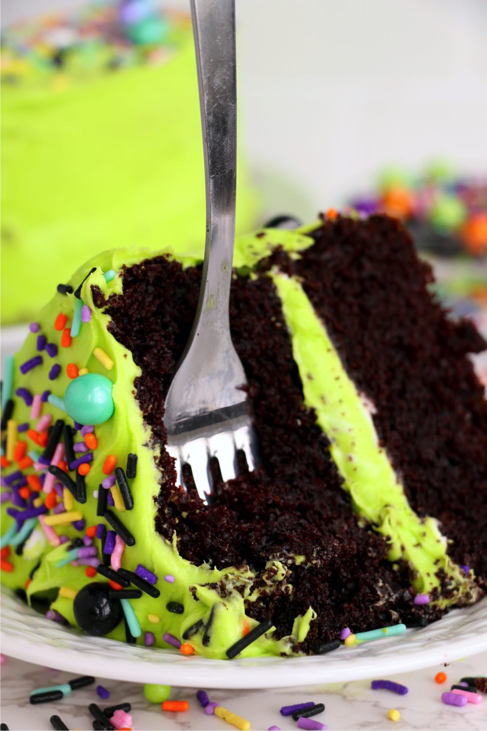 fork digging into piece of chocolate cake