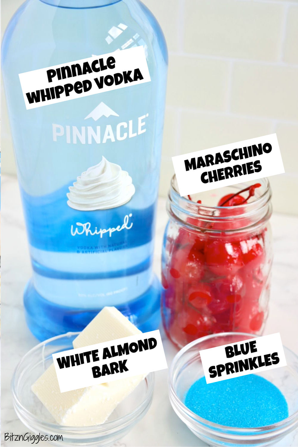 Ingredients for drunken cherry bombs on a white marble table.