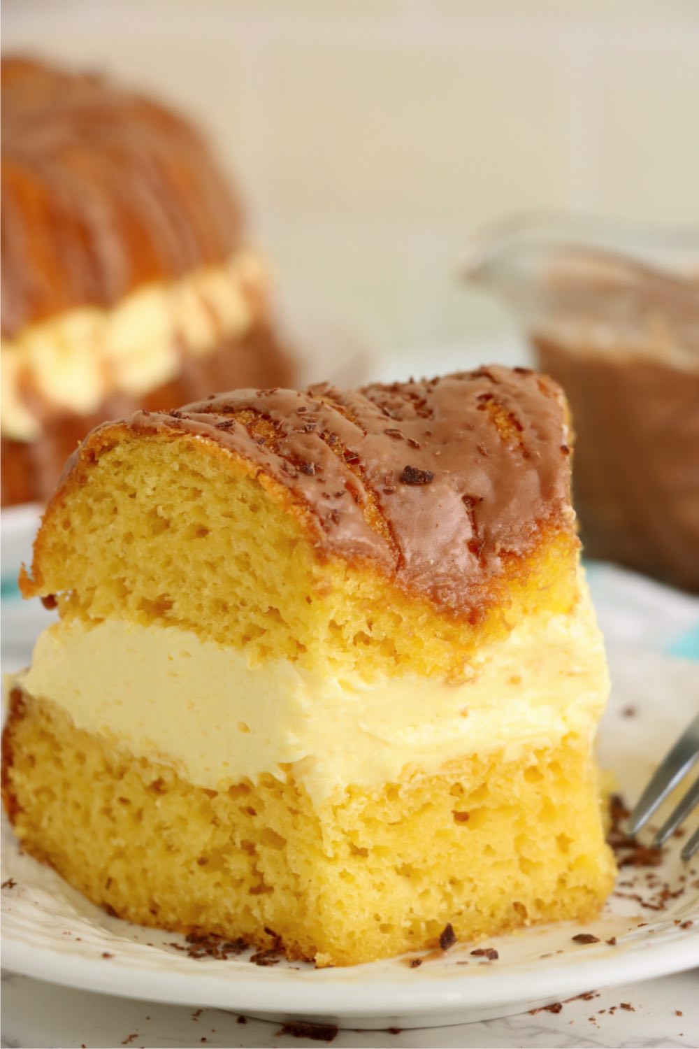 slice of Boston cream cake with a piece out