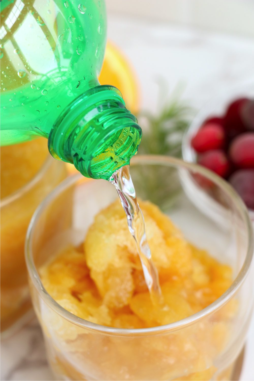 pouring soda into glass filled with brandy slush