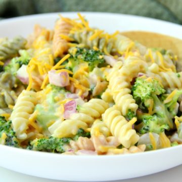 Broccoli Cheddar Pasta Salad - Broccoli, red onion, shredded cheese and rotini pasta tossed in a sweet, creamy dressing! Everyone always asks for seconds!