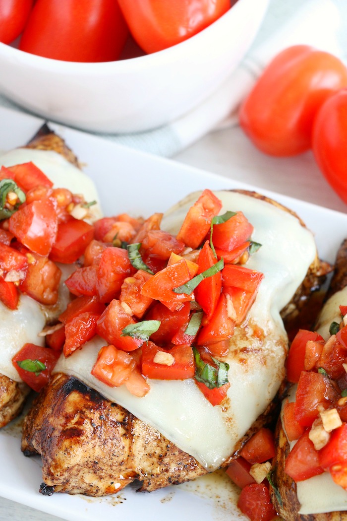 grilled chicken breasts covered with bruschetta