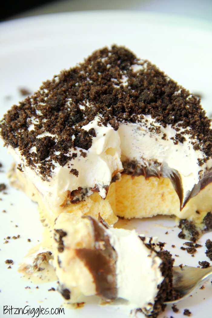 Buster Bar Lasagna - Decadent layers of Oreo cookies, ice cream, hot fudge, Snickers bars and whipped topping make up this delicious 5-layer dessert!