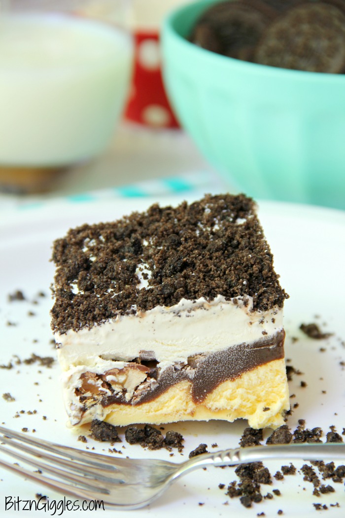 Buster Bar Lasagna - Decadent layers of Oreo cookies, ice cream, hot fudge, Snickers bars and whipped topping make up this delicious 5-layer dessert!