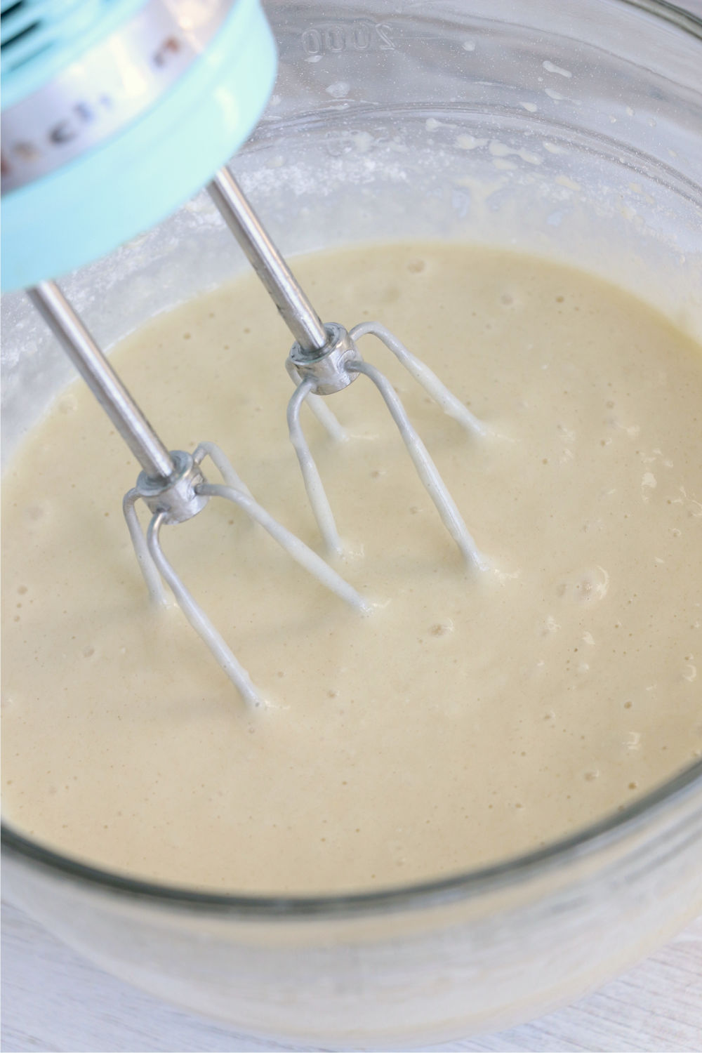 beaters in a bowl of cupcake batter