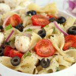 bowl of pasta with tomatoes and black olives